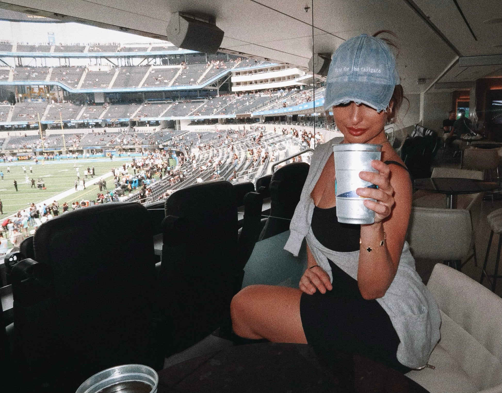 model Eileen Hayman wearing Here for the Tailgate blue hat at football game