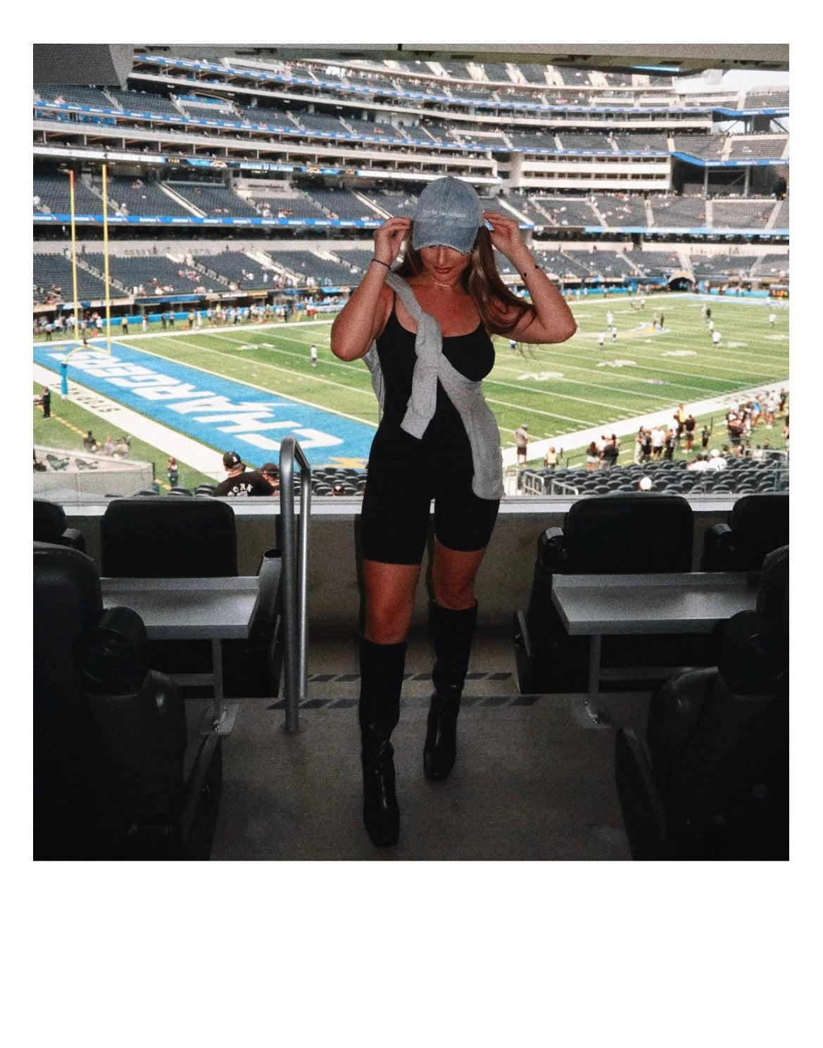 model Eileen Hayman wearing Here for the Tailgate blue hat at football game