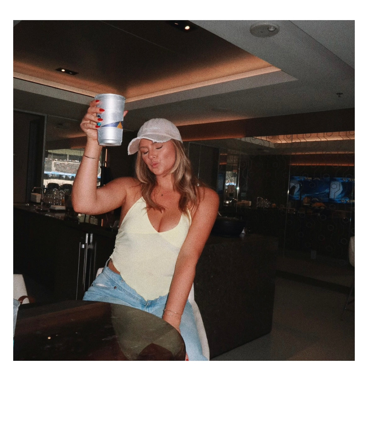 model Paige wearing Here for the Tailgate beige hat at football game