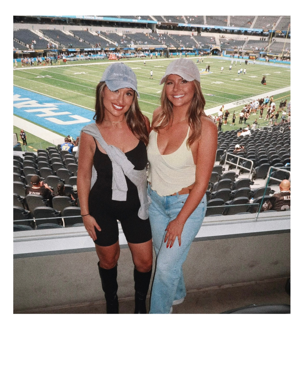 models Eileen Hayman and Paige wearing Here for the Tailgate blue and beige hats at football game